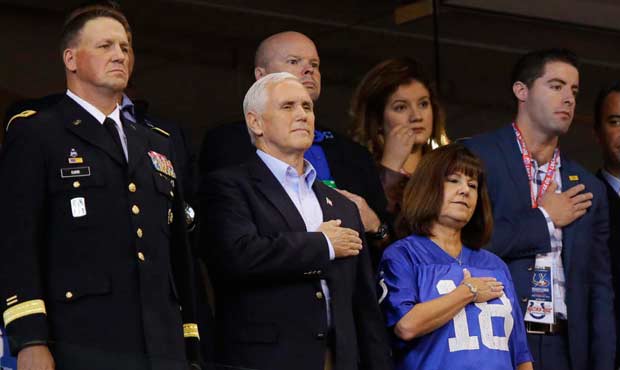 Vice President Mike Pence, front center, stands during the playing of the national anthem before an...