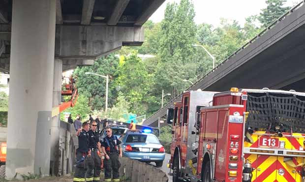 Two construction workers were injured after an elevated basket was hit by a truck on the West Seatt...
