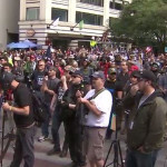 Marchers move through Seattle on the day Donald Trump is inaugurated. (Mike Lewis, KIRO Radio