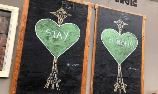 Artwork covers the windows of a closed business in the Ballard neighborhood during the ongoing COVI...