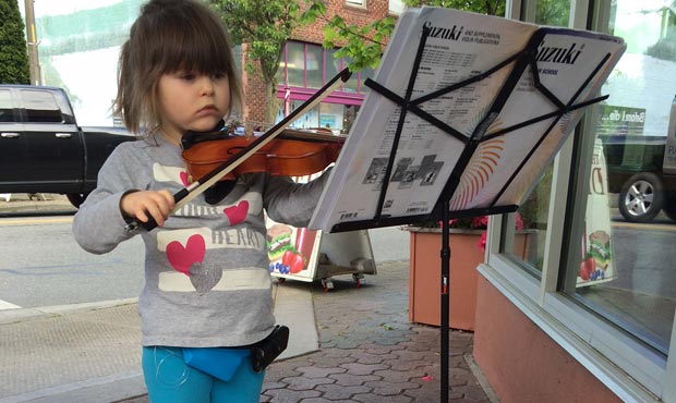Five year old Jovee Holmes loves to play her violin outside the Skagit Valley Coop, and all the mon...