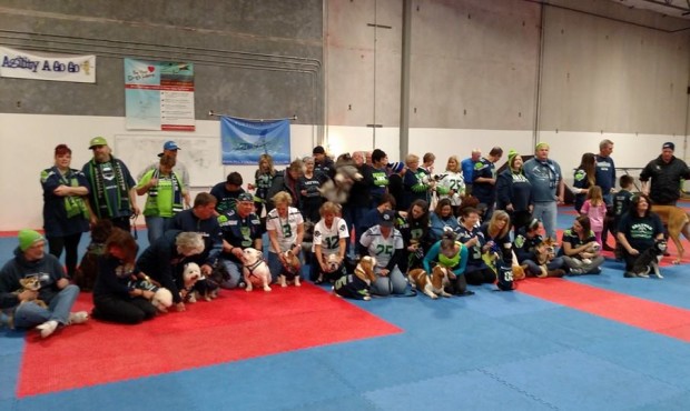 Dogs and their humans gathered Thursday evening for a photo-op and to support their Seattle Seahawk...