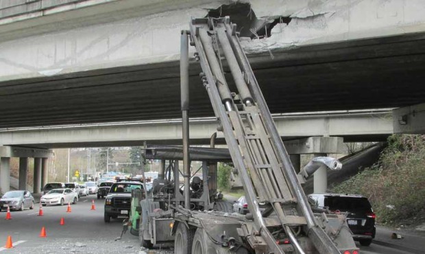 The state is getting around to fixing a giant hole in an overpass over I-90. (WSDOT)...