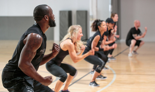 Kam Chancellor works out, and demonstrates an exercise with other trainers, at one of his bootcamp ...