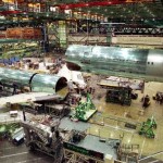 The forward portion of the fuselage of a new Boeing 767-400ER jetliner is lowered into position, directed by a lone worker at lower right, during the jet's final body join June 8, 1999, at Boeing's Everett, Wash., aircraft factory.
