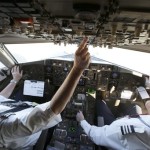 In this Dec.  2013 photo, American Airlines Capt. Paul Wannberg, left, and First Officer Robert Popp prepare a Boeing 757 jet for takeoff from Dallas/Fort Worth International Airport in Grapevine, Texas. The pair is piloting the passenger plane for the last time before it is retired. (AP Photo)