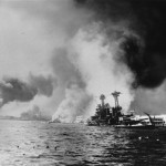 This Dec. 7, 1941 file photo provided by the Dept. of Defense shows the USS California, right, after being struck by two battleships and two big bombs during a Japanese sneak attack on Pearl Harbor. Durrell Conner, who coded and decoded messages for the Navy, was aboard the USS California when it sank in Pearl Harbor on Dec. 7, 1941. Conner will return with 17 family members to remember those who died in the Japanese attack 69 years ago during the Pearl Harbor Anniversary. (AP Photo/DOD)