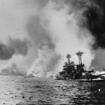 This Dec. 7, 1941 file photo provided by the Dept. of Defense shows the USS California, right, after being struck by two battleships and two big bombs during a Japanese sneak attack on Pearl Harbor. (AP Photo/DOD)