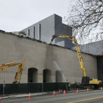 Late Thursday morning, workers used heavy equipment to start chipping away at the 1961 brick facade on the old Mercer Arena. (Feliks Banel photo)