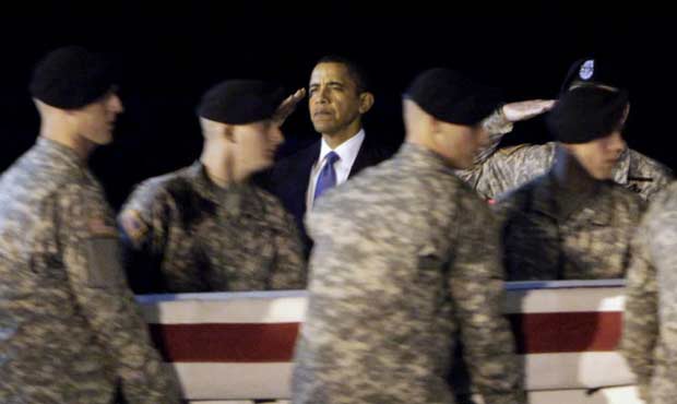 On Oct. 29, 2009, President Barack Obama, center, salutes as an Army carry team carries the transfe...