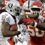  Oakland Raiders running back Marshawn Lynch (24) runs against Kansas City Chiefs outside linebacker Justin Houston (50) during the first half of an NFL football game in Oakland, Calif., Thursday, Oct. 19, 2017. (AP Photo/Marcio Jose Sanchez)