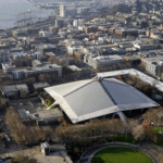 The iconic sloped roof of KeyArena, center, a sports and entertainment venue at the Seattle Center, is seen from above Monday, Dec. 4, 2017, in Seattle. The Seattle City Council on Monday approved a memorandum of understanding with Los Angeles-based Oak View Group in a $600 million privately financed project to renovate the facility, formerly the home of the NBA's SuperSonics. (AP Photo/Elaine Thompson)