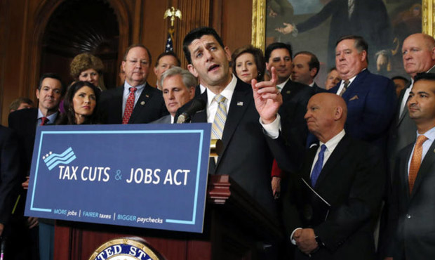 House Speaker Paul Ryan, joined by House Republicans, speaks to the media following a vote on tax r...