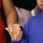   Darwin Micheal Mejia, right, holds hands with his mother, Beata Mariana de Jesus Mejia-Mejia, during a news conference following their reunion at Baltimore-Washington International Thurgood Marshall Airport, Friday, June 22, 2018, in Linthicum, Md. The Justice Department agreed to release Mejia-Mejia's son after she sued the U.S. government in order to be reunited following their separation at the U.S. border. She has filed for political asylum in the U.S. following a trek from Guatemala. (AP Photo/Patrick Semansky)