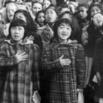 In this April 1942 photo made available by the Library of Congress, children at the Weill public school in San Francisco recite the Pledge of Allegiance. Some of them are evacuees of Japanese ancestry who will be housed in War Relocation Authority centers for the duration of the war. Roughly 120,000 Japanese immigrants and Japanese-Americans were sent to camps that dotted the West because the government claimed they might plot against the U.S. (Dorothea Lange/U.S. War Relocation Authority via AP)