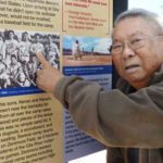 Kenso Zenimura, an 89-year-old former Japanese professional baseball player, points to a photo showing him held at an internment camp for Japanese immigrants and Japanese-Americans during World War II in Chandler, Arizona as the city unveils on Jan. 21, 2017 a series of panels with information about the area's wartime history. The city held a ceremony to unveil the panels near Nozomi Park, the complex of baseball parks and swimming pools, ahead of the 75th anniversary of the Feb. 19, 1942, signing by President Franklin Roosevelt of an executive order which resulted in the incarceration of Japanese immigrants and U.S. citizens of Japanese descent. (Kyodo via AP Images)