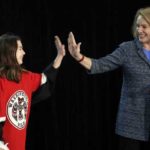In this Oct. 8, 2018, file photo, Seattle Mayor Jenny Durkan, right, high-five's Washington Wild hockey team wing Jaina Goscinski, 11, as Tod Leiweke, CEO of NHL Seattle, looks on during a news conference in Seattle. The NHL Board of Governors is meeting, Tuesday, Dec. 4, 2018, in Sea Island, Ga., to give final approval to Seattle's bid to add the league's 32nd team. (AP Photo/Elaine Thompson, File)