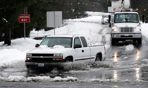 A truck drives through standing water on a highway offramp, Tuesday, Feb. 12, 2019, in Olympia, Was...