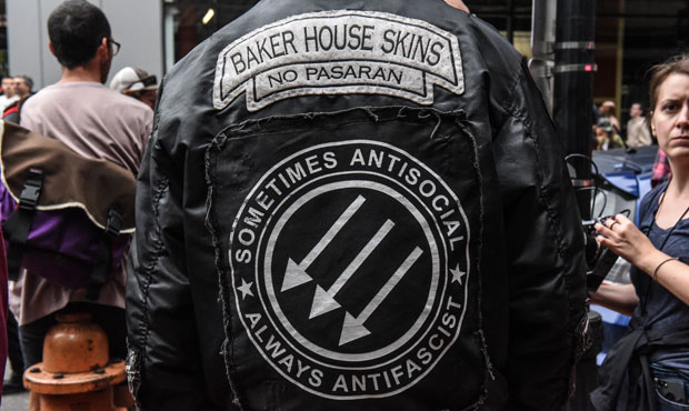 A counter-protester wears a jacket with an Antifa symbol during an alt-right rally on August 17, 20...