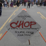 
              A sign reads "Welcome to CHOP," Sunday, June 14, 2020, inside what has been named the Capitol Hill Occupied Protest zone in Seattle. Protesters calling for police reform and other demands have taken over several blocks near downtown Seattle after officers withdrew from a police station in the area following violent confrontations. The CHOP name is a change from CHAZ (Capitol Hill Autonomous Zone) that was used earlier in the week. (AP Photo/Ted S. Warren)
            