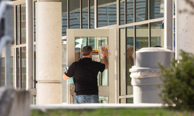 A staff member cleans a door at Bothell High School on February 27, 2020 in Bothell, Washington. (P...