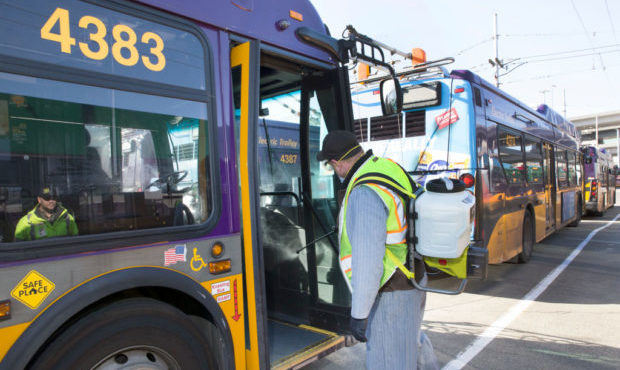 Larry Bowles, an equipment service worker for King County Metro, sprays Virex II 256, a disinfectan...