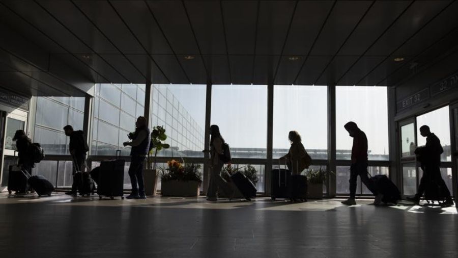 Travelers walk with their luggage in the Ben Gurion Airport near Tel Aviv, Israel, Sunday, Nov. 28,...