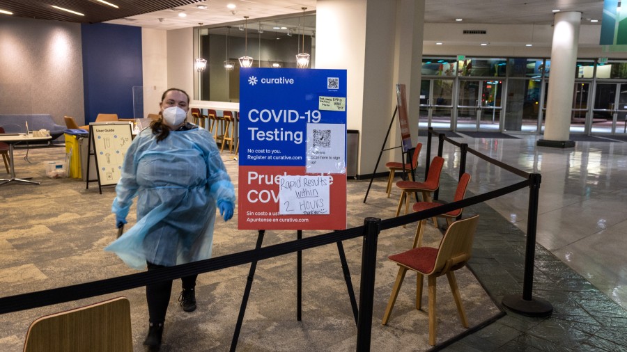 A health worker waits at an empty Covid-19 testing center at the Washington State Convention Center...