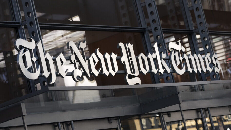 FILE - A sign for The New York Times hangs above the entrance to its building, May 6, 2021, in New ...