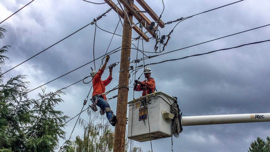 Puget Sound Energy crews work on a powerline....