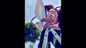 Photo: Logan, who lives in Poulsbo, saw the damage when he was walking down the street. He stitched the slashed Pride banners back together on Saturday afternoon.