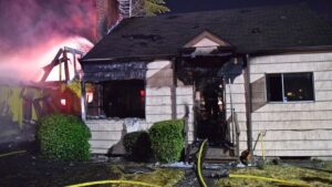 Photo: A house in Columbia City was damaged by a fire that started in a nearby construction site. 
