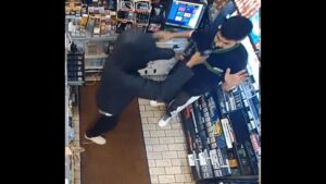 Photo: Masked suspect presses gun into victim’s face during one of the robberies.