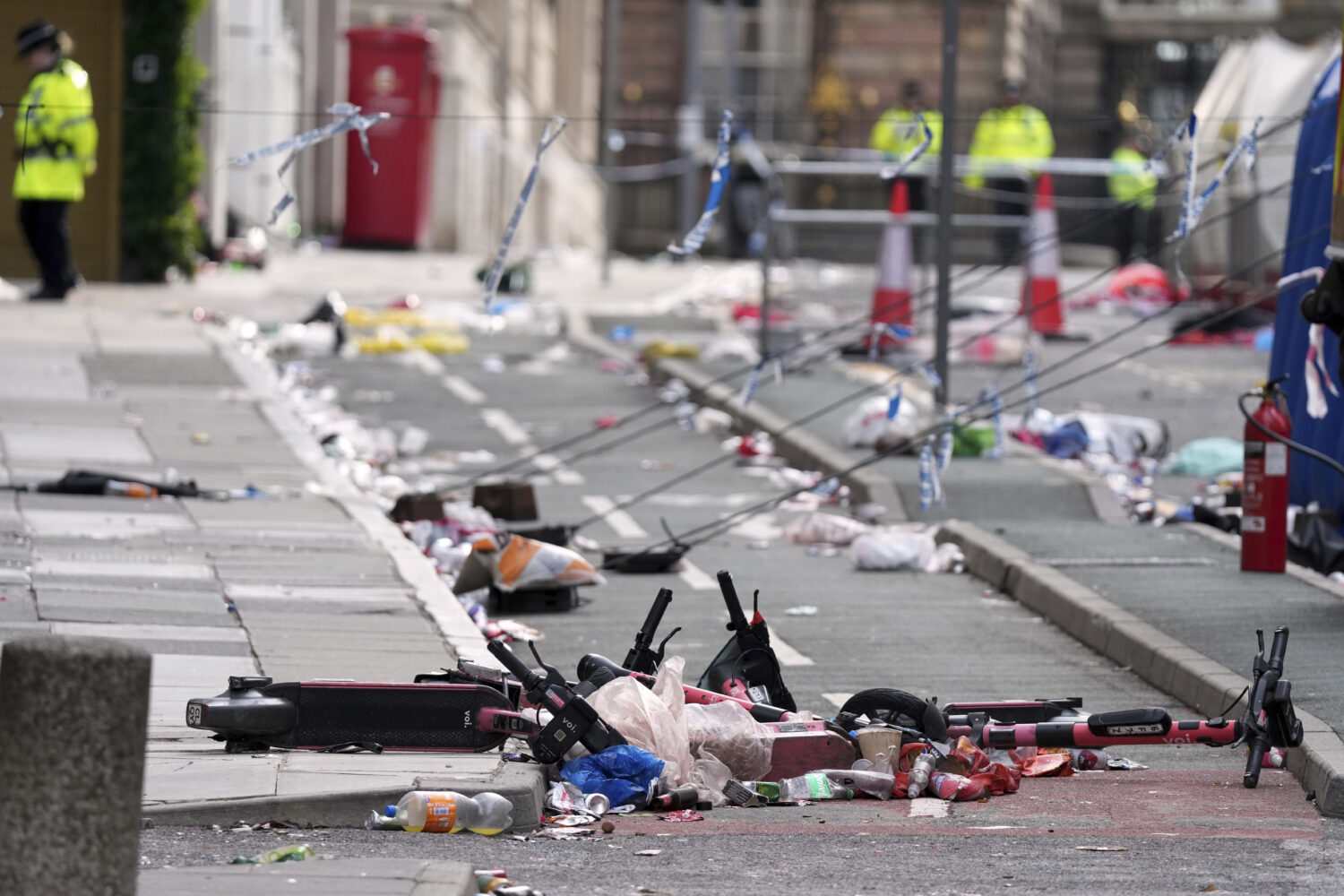 Scooters lie on the site where a 53-year-old British man plowed a minivan into a crowd of Liverpool...