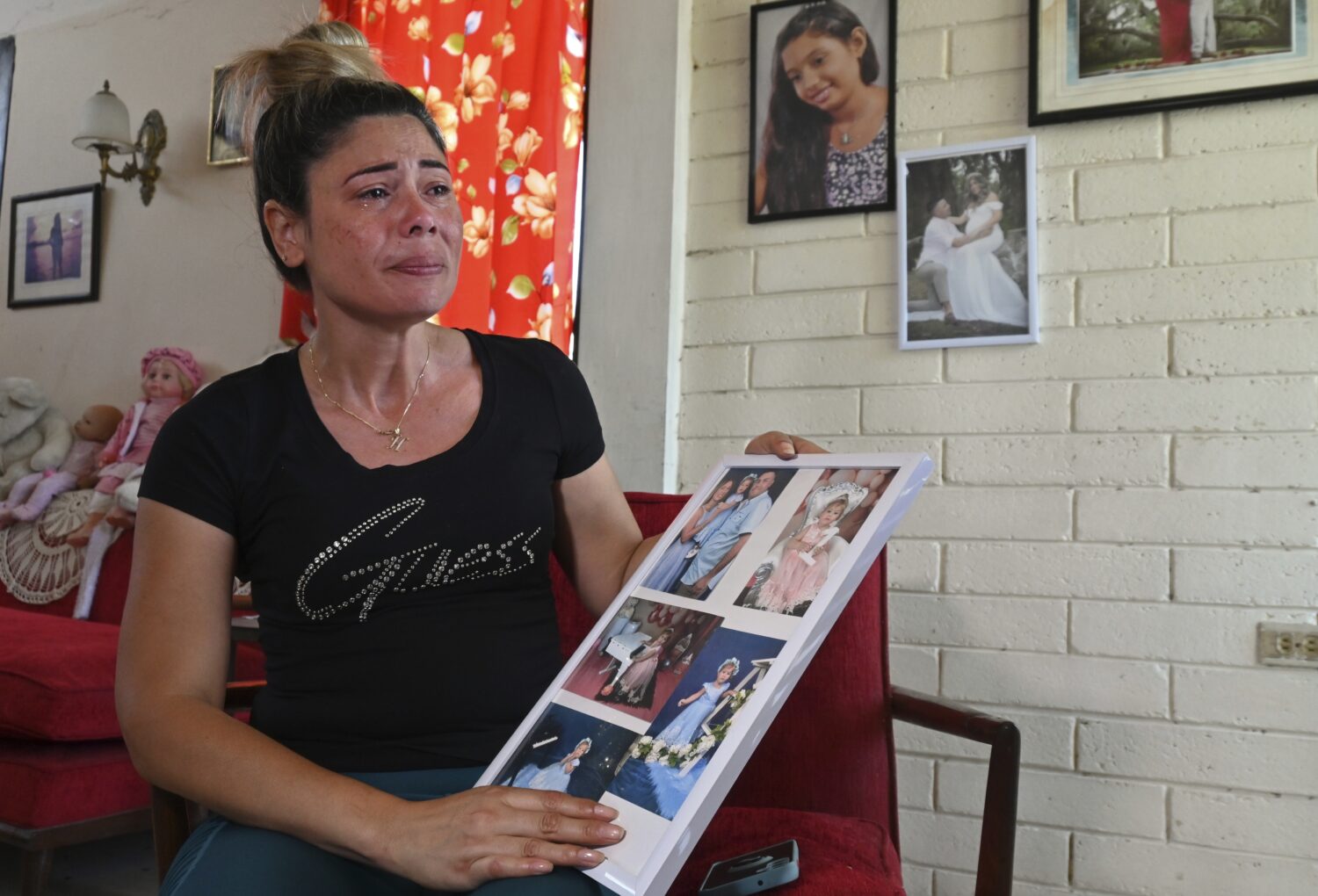 Heidy Sánchez, who was deported from the US to Cuba, cries while showing photos of her daughter an...