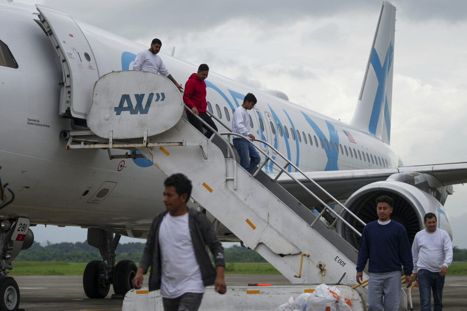 FILE - Honduras migrants who were deported from the U.S. deplane at Ramon Villeda Morales Airport, ...