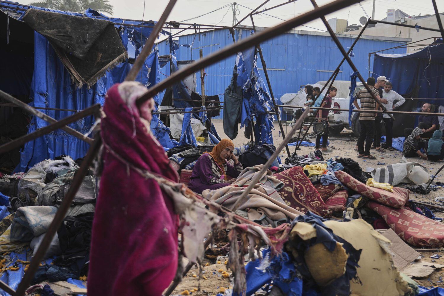 Palestinians inspect the damage caused by an Israeli airstrike that struck tents at Al-Aqsa Hospita...