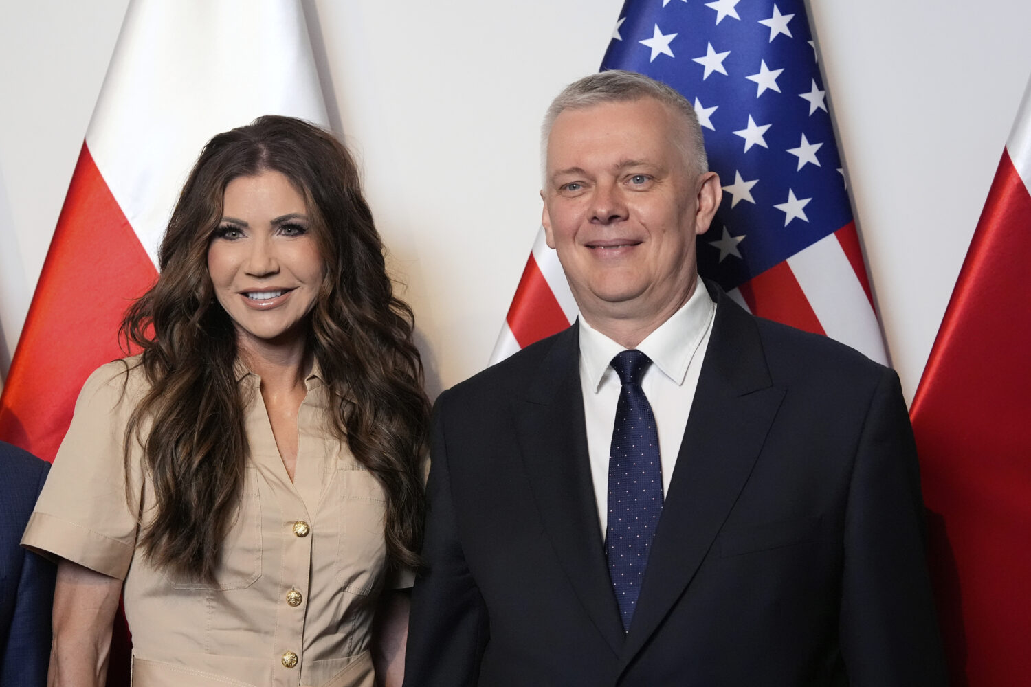 Homeland Security Secretary Kristi Noem, left, poses with Poland's Interior Minister Tomasz Siemoni...