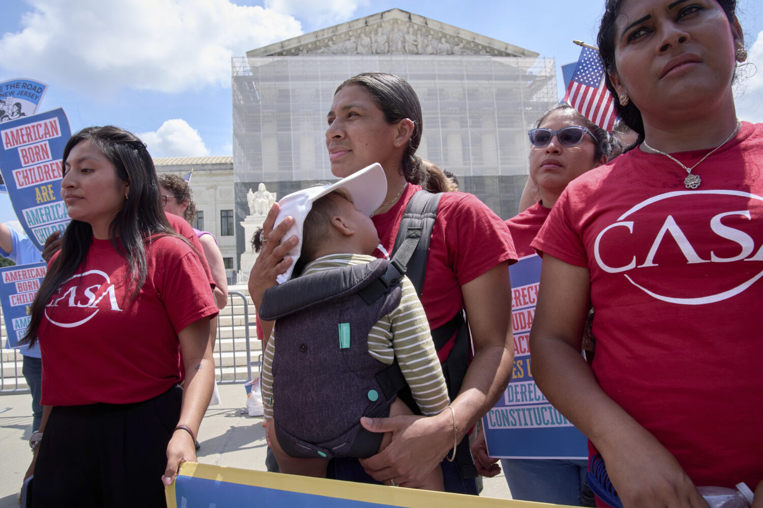 A woman from CASA Maryland holds her 9-month-old baby as she joins others in support of birthright ...