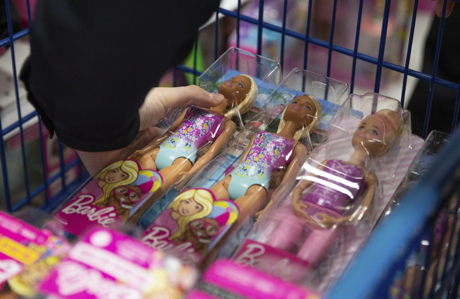 A collection of Barbie dolls are placed into a cart in Bowling Green, Ky., on Tuesday, Dec. 7, 2021...