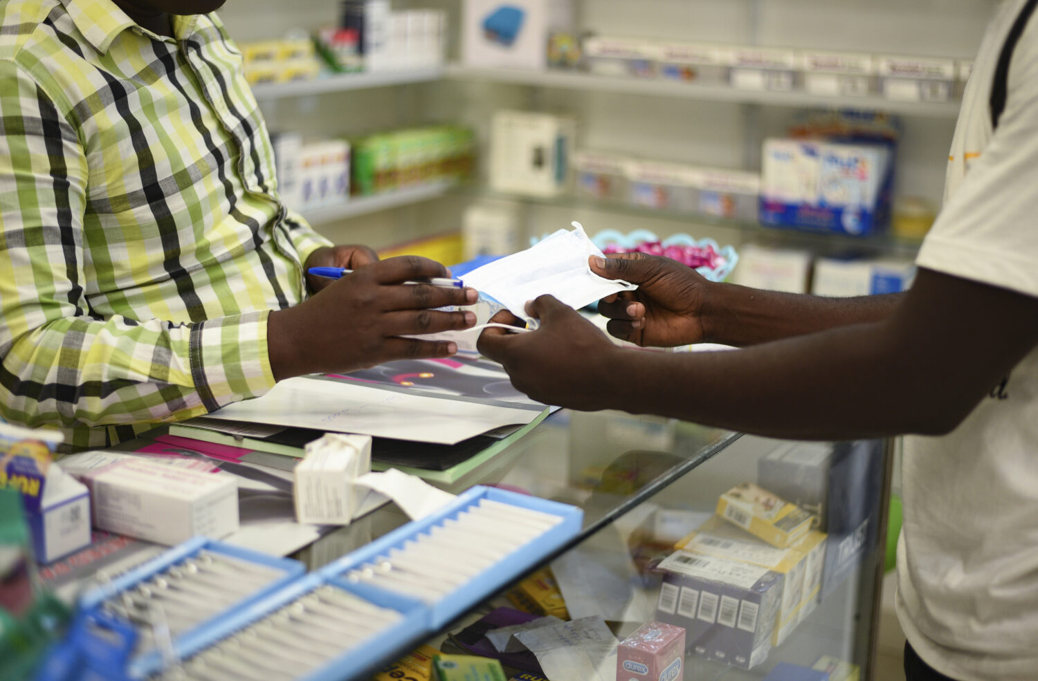 FILE — In this Feb. 6, 2020 file photo, a man buys a face mask at a pharmacy in Kitwe, Zambia. Za...