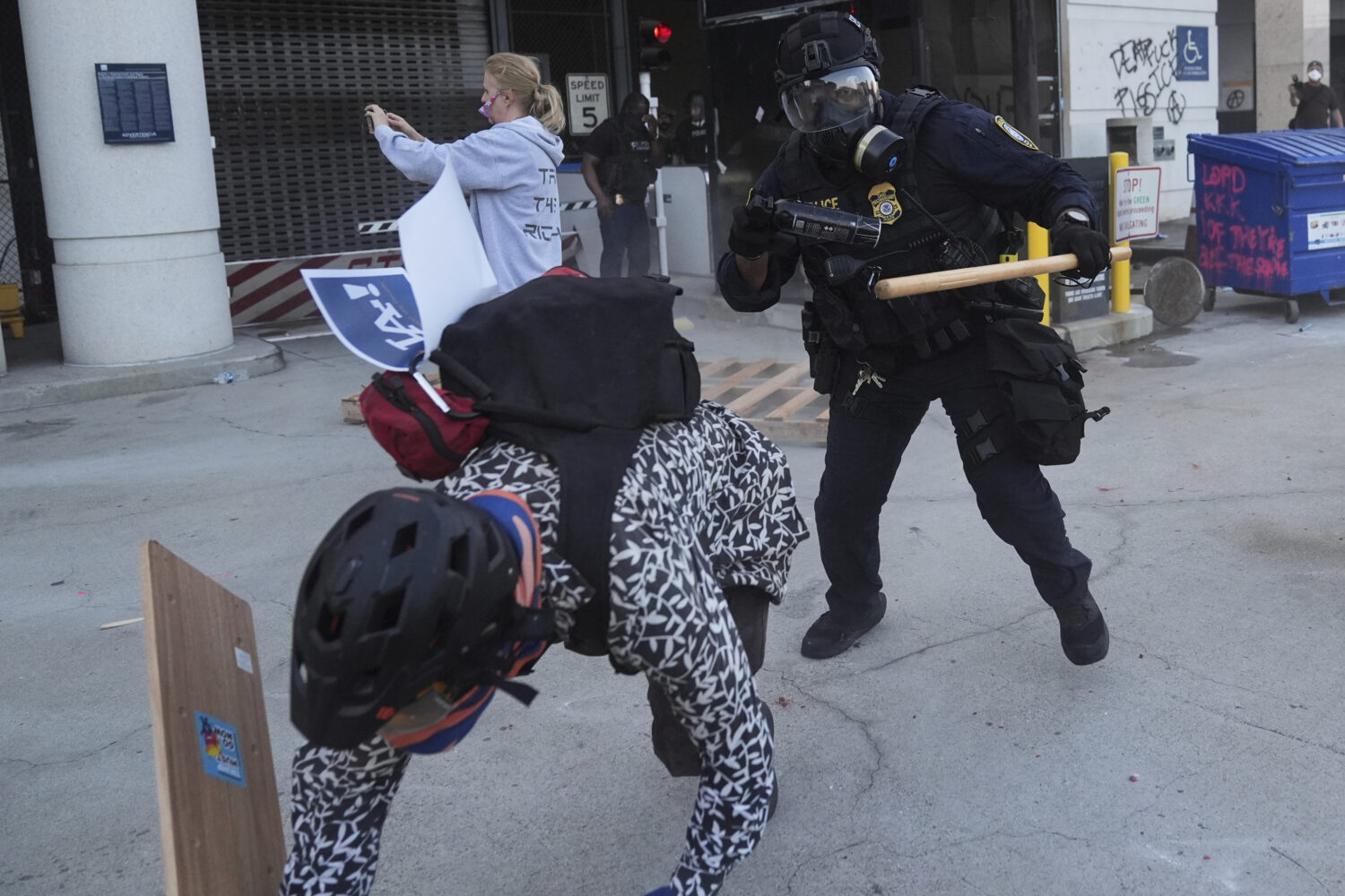 A protester attempts to evade a Department of Homeland Security officer after federal immigration a...