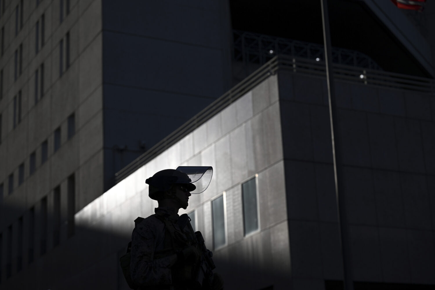 A U.S. Marine stands guard outside the downtown Metropolitan Detention Center Tuesday, June 17, 202...