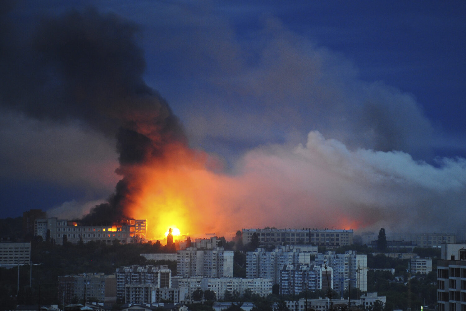Fire and smoke rise from the site where a Russian missile struck a residential area in Kharkiv, Ukr...