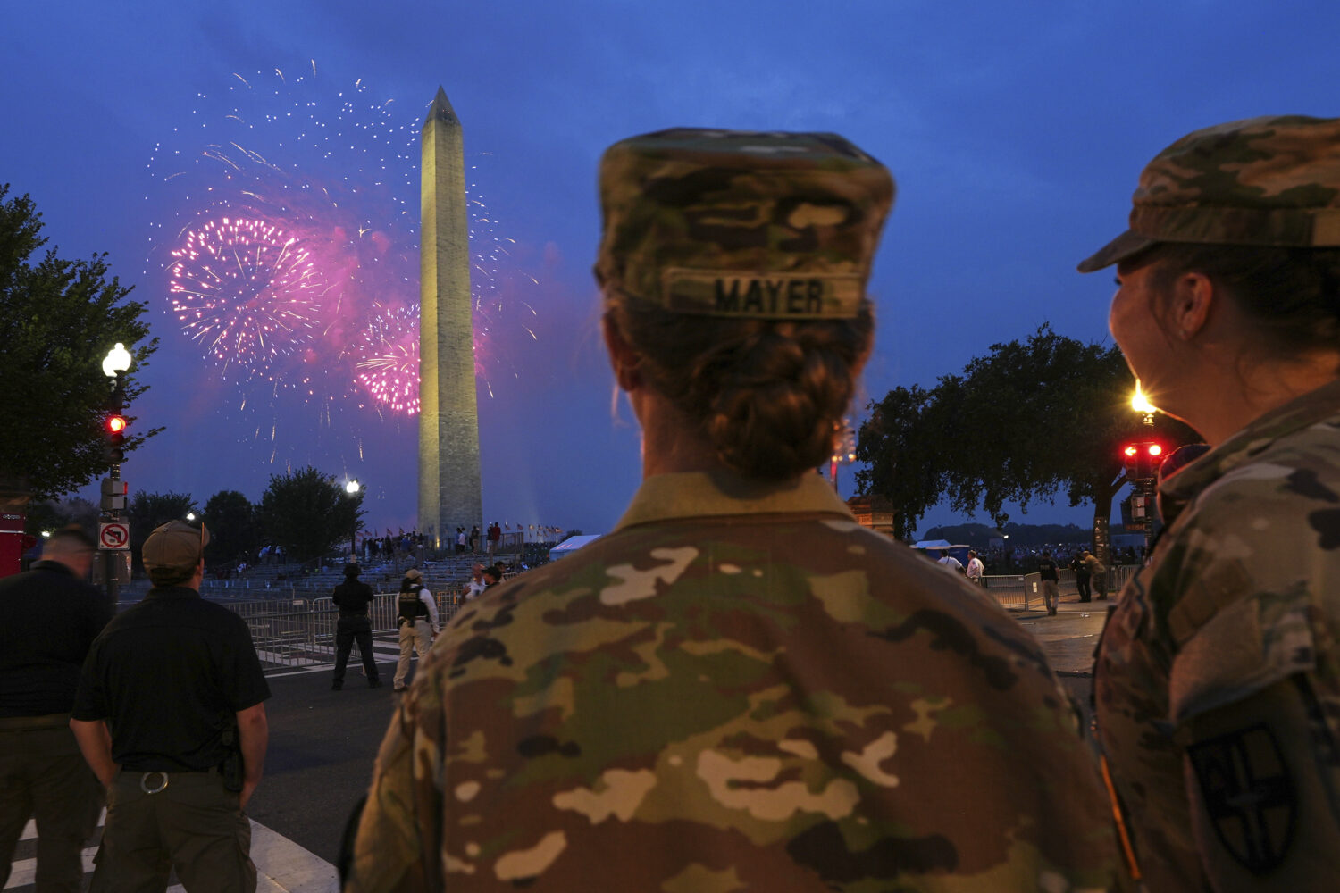 U.S. Army 2nd Lt. Hayle Mayer, left, and Corporal Addison Merrell, watch fireworks at the Washingto...
