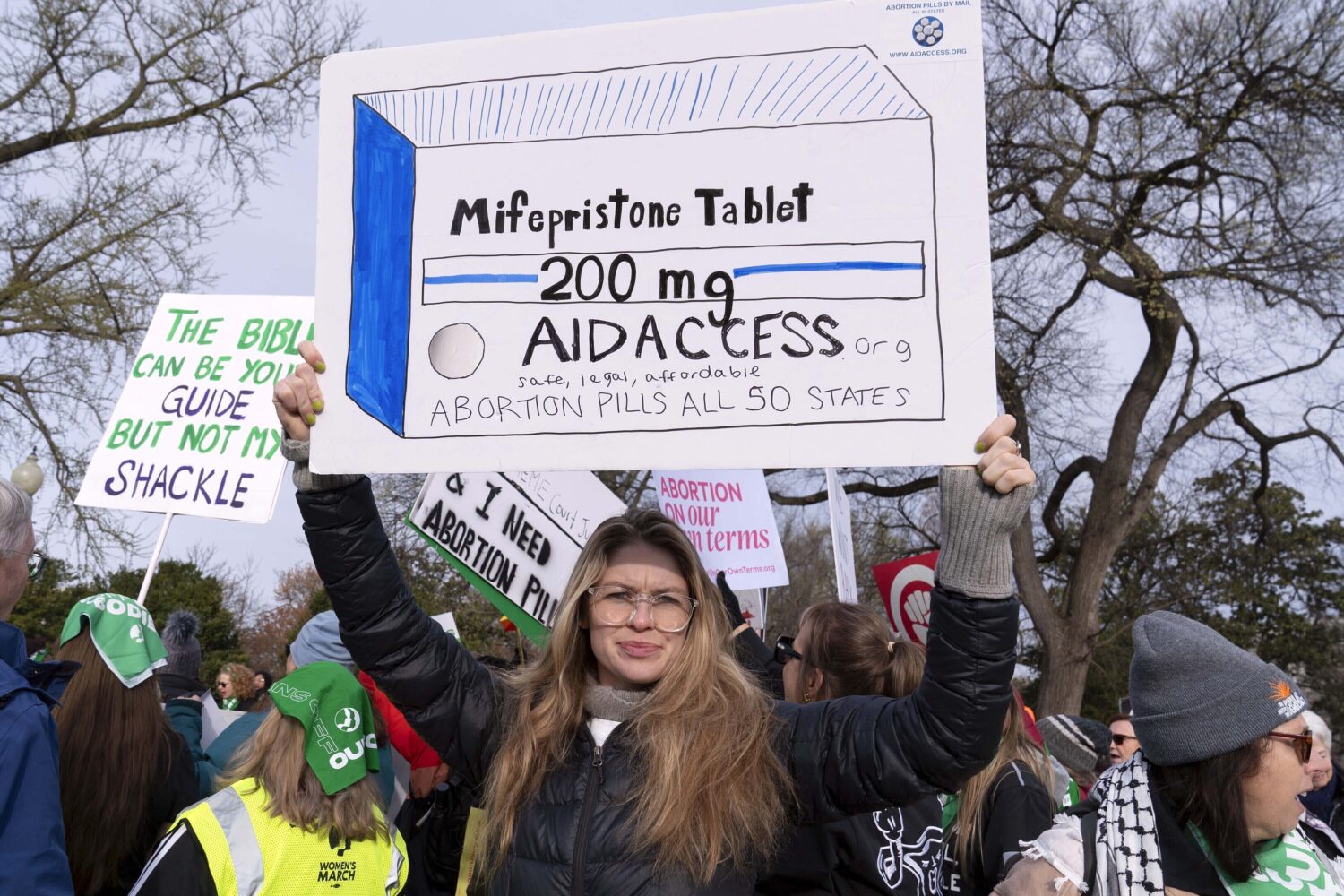 FILE - Abortion-rights activists holds a signs as they protest outside of the Supreme Court during ...