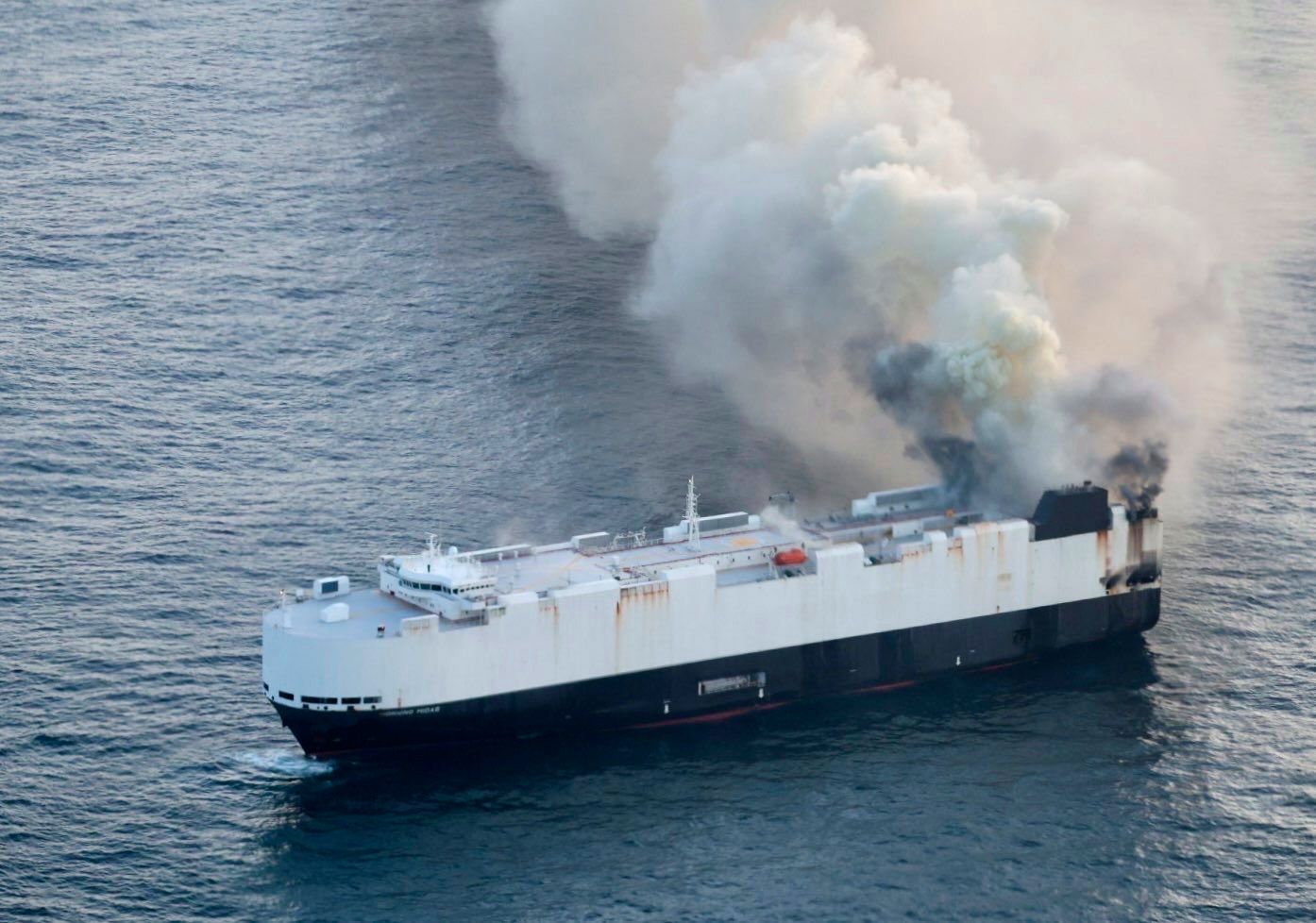 In this photo provided by the U.S. Coast Guard, smoke rises from cargo vessel Morning Midas approxi...