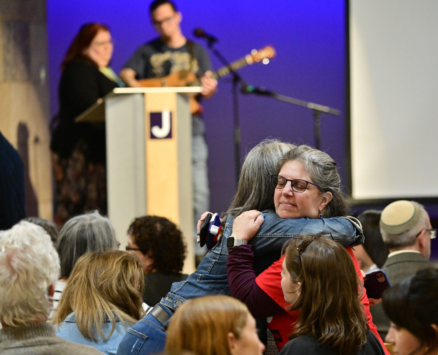Women embrace before a community vigil at the Boulder Jewish Community Center to mark an attack in ...