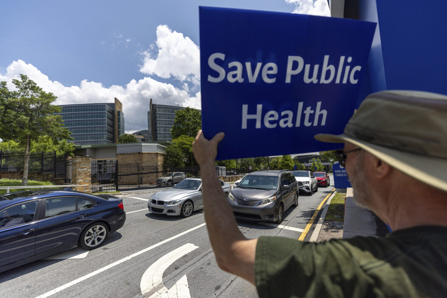 Michael Beach protests President Donald Trump's proposed cuts to health services outside the Center...