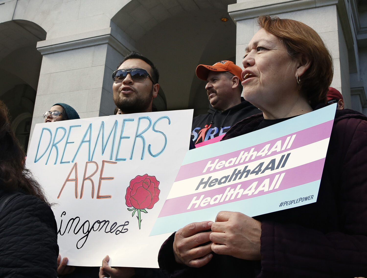 FILE - Supporters of proposals to expand California's government-funded health care benefits to und...